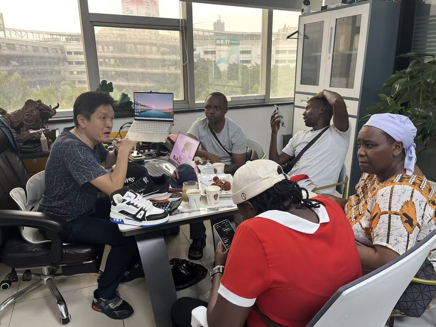 Tim discussing products with overseas buyers in the Chupu office near Yiwu Market