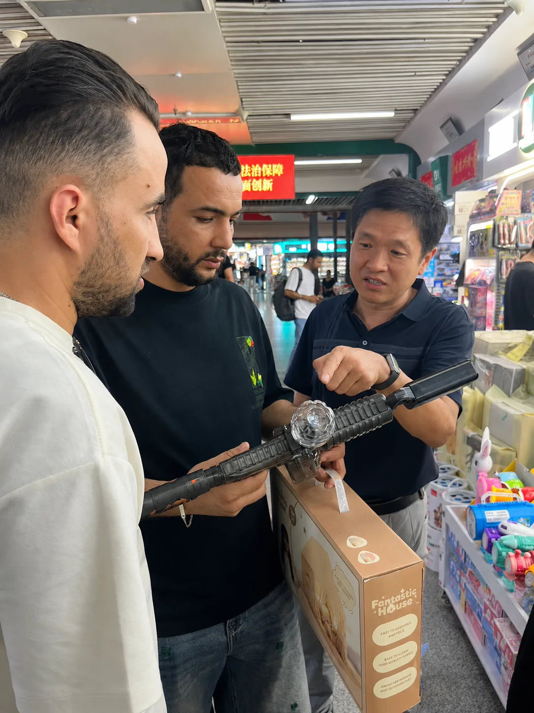 Tim comparing a product with overseas bulk buyers in Yiwu Market