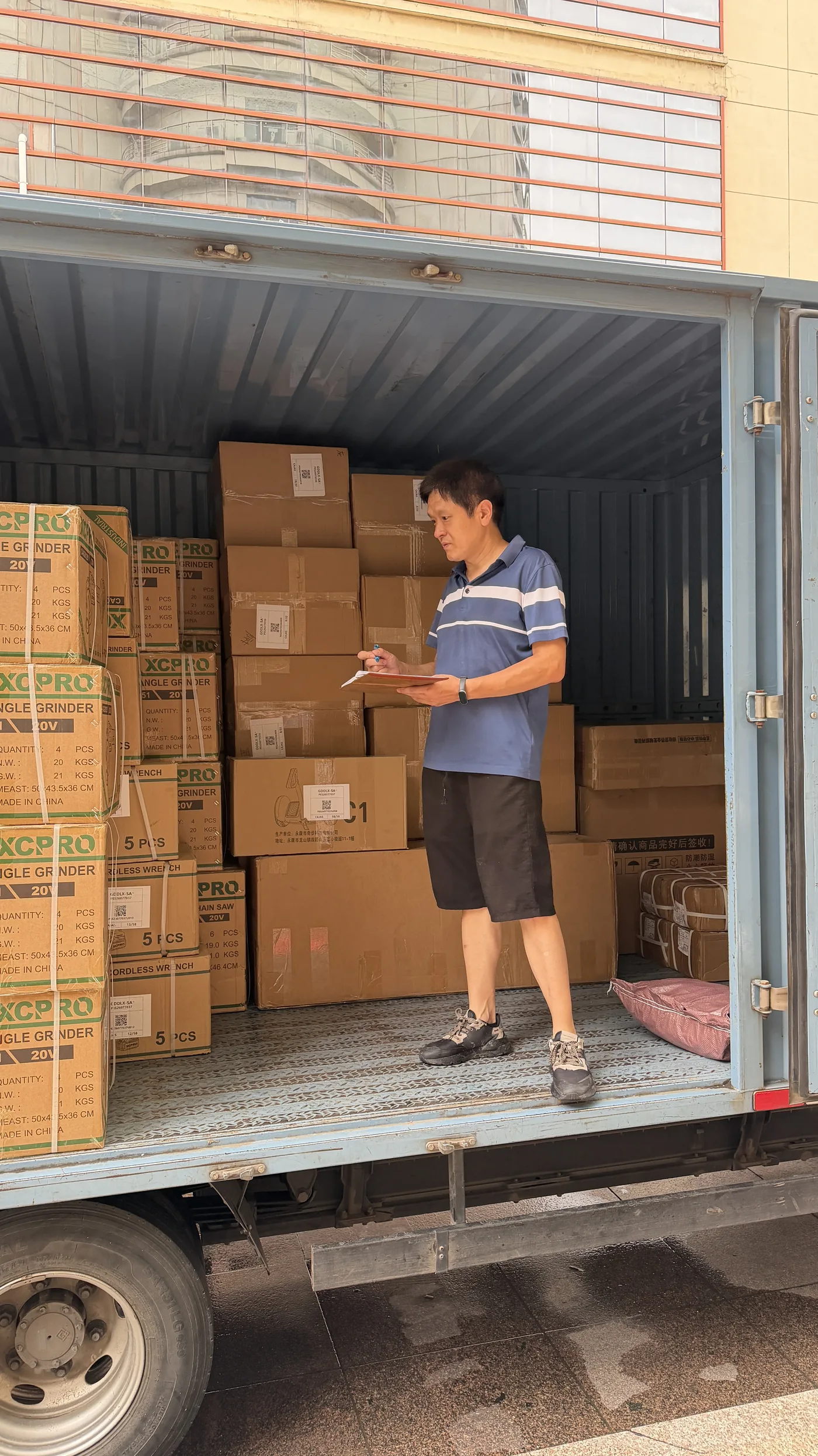Tim checking cartons and order details before loading